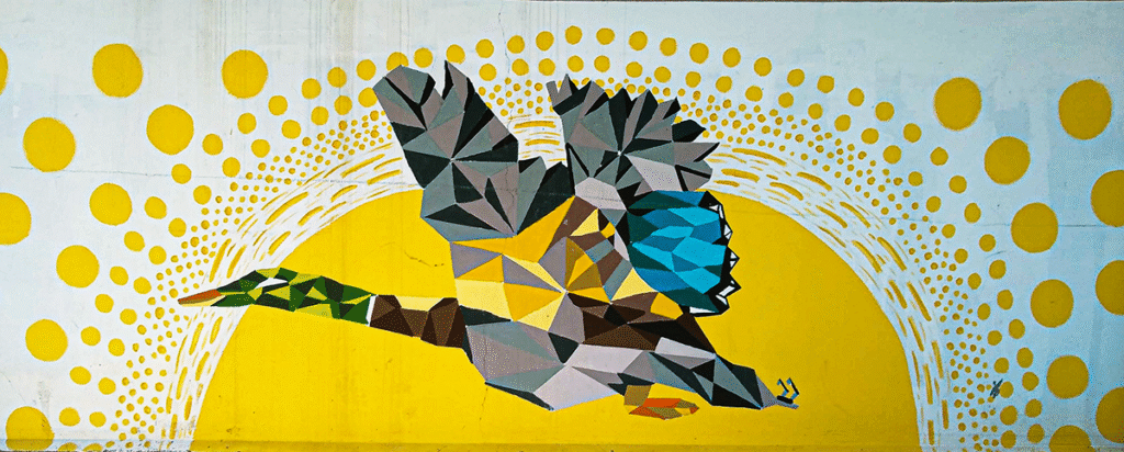 An abstract mural located in Harrison, Arkansas, depicting a colorful duck in flight against a bright yellow sun.