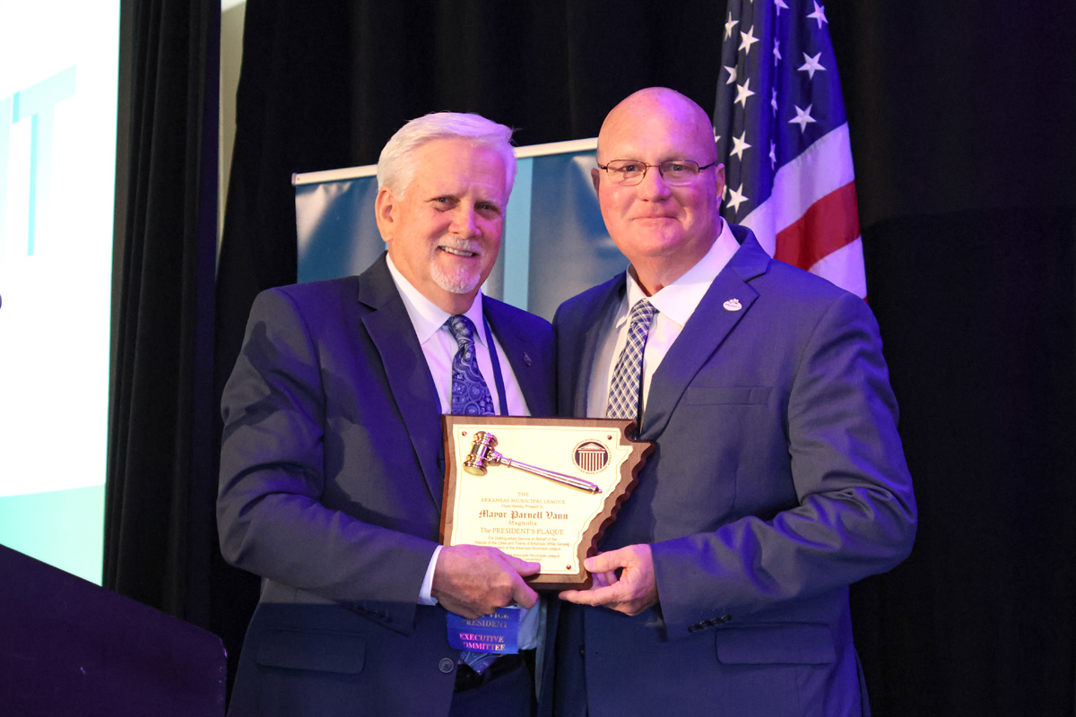 Greenwood Mayor and 2025-2026 League President Doug Kinslow, left, presents outgoing League President and Magnolia Mayor Parnell Vann with a plaque in recognition of his service to the League during the New Officers and Awards Luncheon on Friday, June 20.
