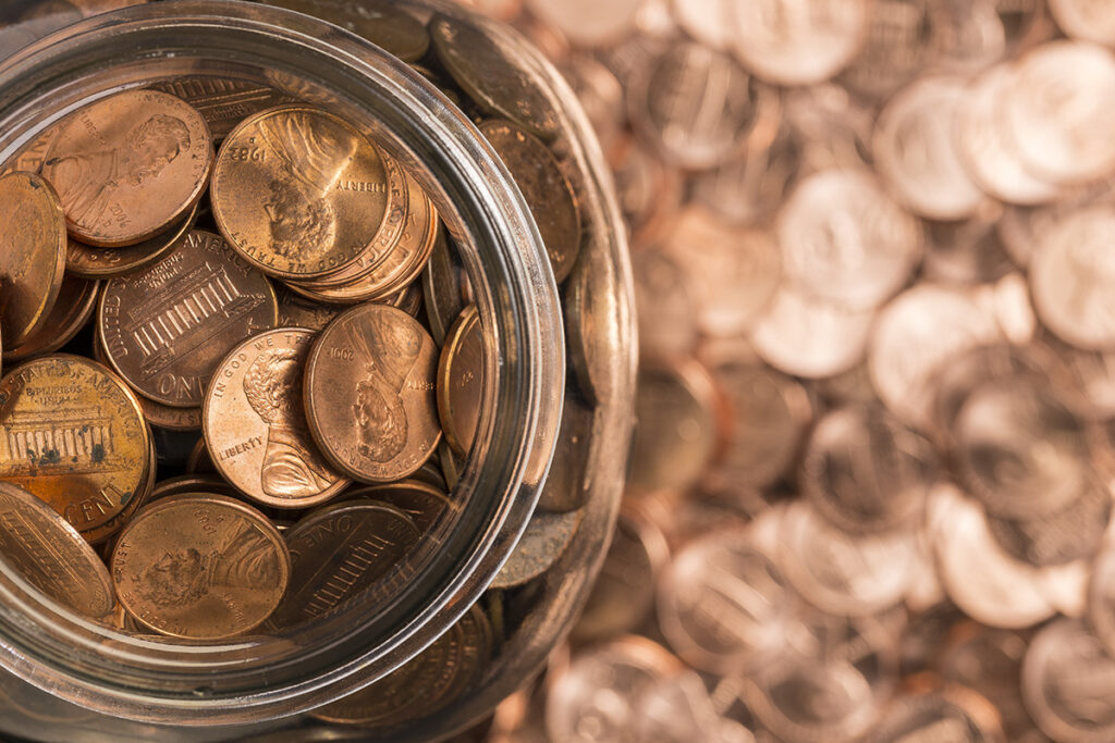 image of a jar of pennies surrounded by pennies and looking from above